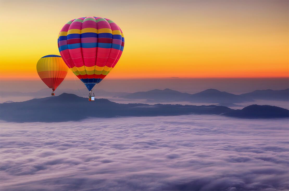 Aerial view from colorful hot air balloons flying over with the mist at Pha Tung mountain in sunrise time
